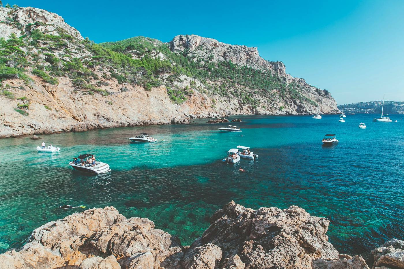 Boats moored in a turquoise bay on the Mallorca coast, Spain