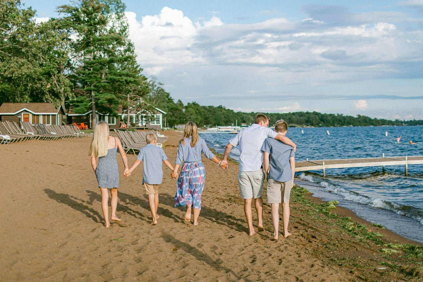 A family walking hand in hand along the beach